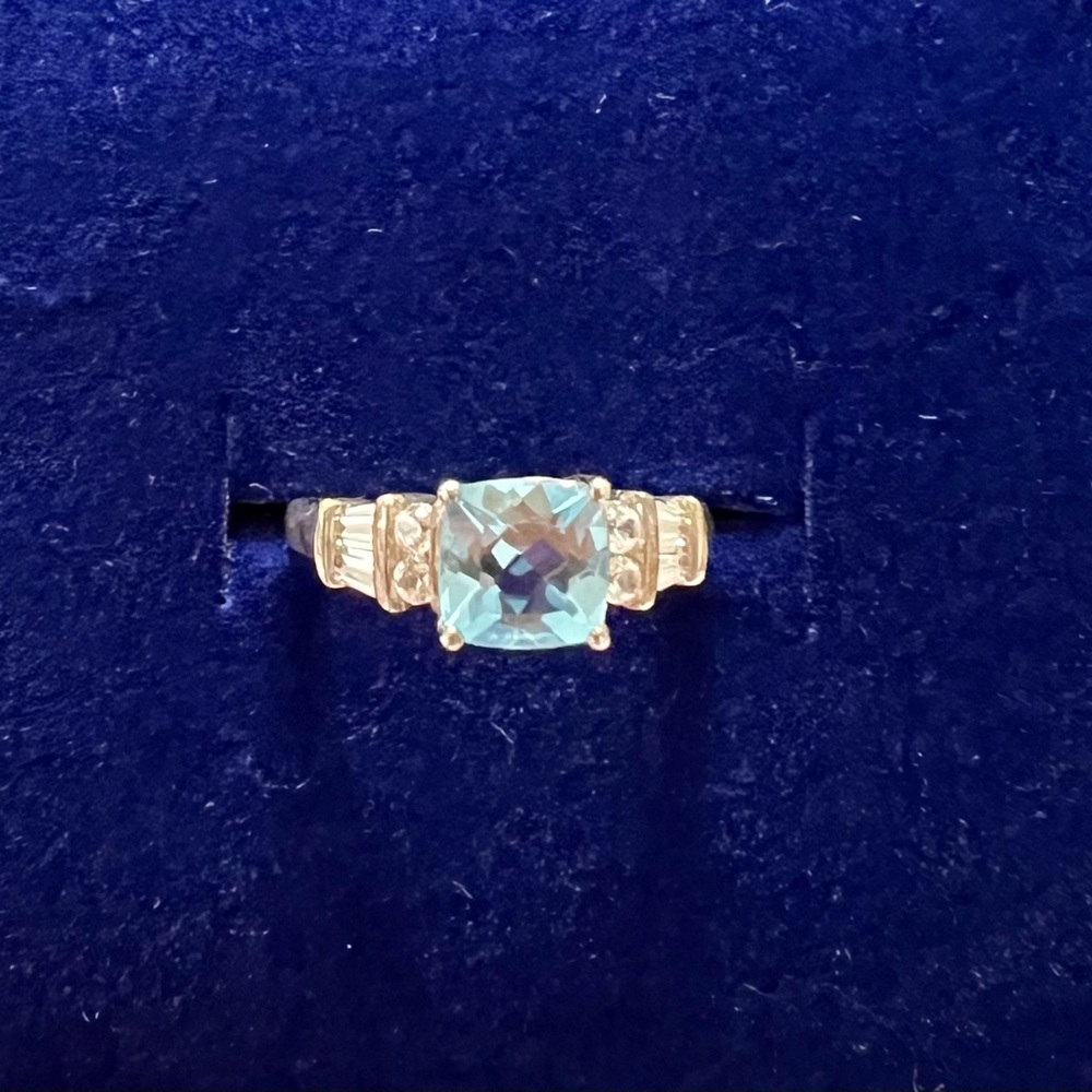 Blue Topaz set in Sterling Silver with eight side stones. Size approx 5.75.